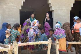 Angelina Jolie (right) listens to displaced women following rains and floods during the monsoon season, in village Ibrahim Chandio, Dadu, Pakistan.