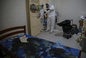 Bodily fluids have stained the bed of a dead person, so trauma cleaner Rahman Razali and his friend and assistant Syed Ali discuss a plan to clean up the area. The body had been removed by the undertaker before their arrival.