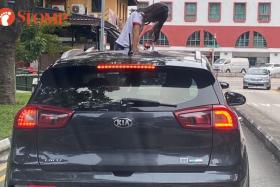 A young girl was caught on camera sticking her head and shoulders out of the sunroof of a stationary Kia Niro at Ah Hood Road on Sunday.