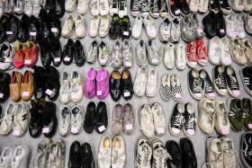 Shoes retrieved by police from the scene of a fatal Halloween crowd surge that killed more than 150 people in the Itaewon district are displayed at a gymnasium for relatives of victims to collect on Nov 1, 2022. 