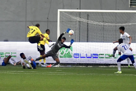Borussia Dortmund’s Donyell Malen (No. 21) scoring in their 7-2 friendly win over the Lion City Sailors at the Jalan Besar Stadium. 