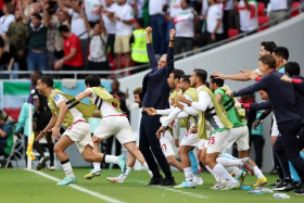 Iran&#039;s players and coach Carlos Queiroz celebrating their first goal against Wales in their World Cup match on Nov 25, 2022. 