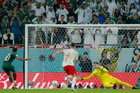 Poland's goalkeeper Wojciech Szczesny stopping a penalty by Saudi Arabia's Salem Al-Dawsari on Saturday. 