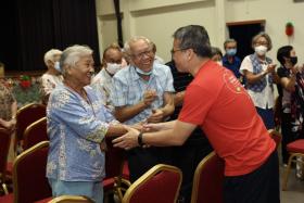 Minister for Culture, Community and Youth Edwin Tong greeting resident at Siglap South Community Centre on Friday.