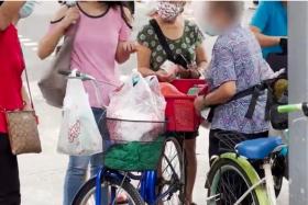 Elderly woman sells chicken from bicycle to earn extra cash