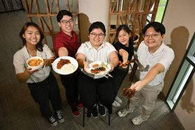 Temasek Polytechnic students (from left) Cheryl Pow, Jacob Ang, Kathleen Tay, Annabel Teo and Benedict Lim with the local dishes they recreated using plant-based proteins. ST PHOTO: LIM YAOHUI
