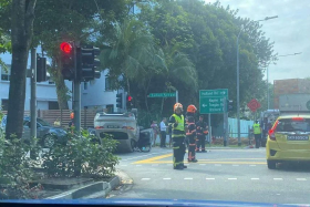 A photo of the aftermath of the accident showed an overturned car at the junction of Taman Serasi and Cluny Road. PHOTO: SG ROAD CHAT/TELEGRAM
