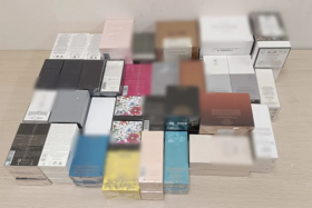 More than 1,100 trademark-infringing bottles of perfume worth more than $91,000 in street value were seized during the operation. PHOTO: SINGAPORE POLICE FORCE
