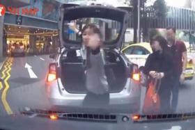 Woman flashes middle finger after getting honked at for blocking traffic outside Paragon