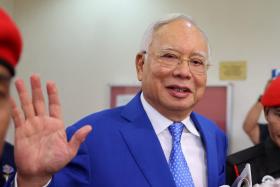 Najib Razak's jail term halved, fine reduced