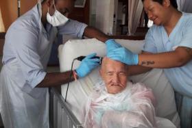 Disabled elderly get free haircuts at Indian Barber Shop