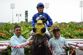 Benny Woodworth savouring his first success for the PSM Stable aboard Star Victory at Kranji on Feb 17. The winners are led in by two James Peters staff, brothers Zairi (far left) and Rosly Othman. 