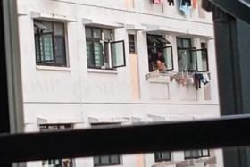 Woman in Yishun balances dangerously on windowsill 