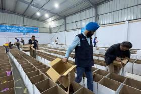 The Mercy Relief team, led by chairman Satwant Singh, preparing 20,000 food boxes in Ismailia.