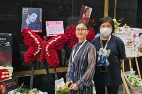 Ms Carrie (in mask) travelled from China to remember her idol at the spot where he died.