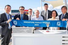 The Singapore Pools delegation headed by its chief product officer Simon Leong (right), along with (from left) senior manager (product content) Steven Tan, board member Lee Kwok Cheong and wife Sachiko Tamamura (second from right) posing with Perth Racing&#039;s director Evan Stewart (in glasses), winning owner O.J. Hubber and winning trainer Daniel Pearce (grey jacket), after Oly&#039;s Choice won the Singapore Pools Trophy 2024 (1,400m) at Ascot, Perth on April 13. 
