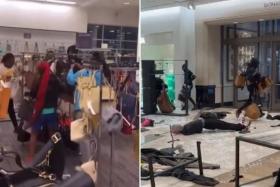 Video clips posted on social media show mobs of up to 50 people rampaging through high-end retailers.
