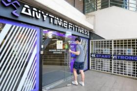 A gym-goer entering the Anytime Fitness at Bukit Timah Shopping Centre, on Dec 21, 2021.