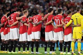 Manchester United players observing a moment of silence for Queen Elizabeth II during their Europa League match. The English Premier League has postponed its matches after the death of the monarch.