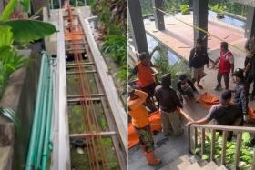 The workers were killed when the steel cable supporting the lift suddenly failed, plunging them 100m down a steep embankment.
