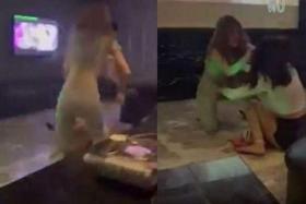 In a video of the scuffle between two women at a karaoke lounge, one of them can be seen grabbing a pot of steaming soup and pouring its contents over the other woman. 
