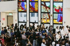 Catholics attend a Good Friday service at the Church of St Anthony of Padua in Woodlands on April 15, 2022.
