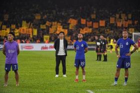 Singapore head coach Takayuki Nishigaya (centre) thanks Singaporean fans after their loss to Malaysia during the AFF Mitsubishi Electric Cup match.