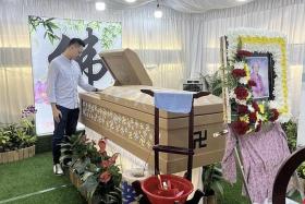 The final well-wishes of her grandchildren were scribbled directly onto the surface of Ms Wang Jin Lian's cardboard coffin.