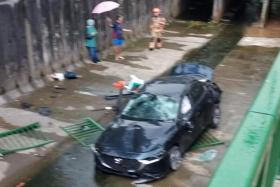 A photo of the accident shows at least three canal railings in the canal near the car.