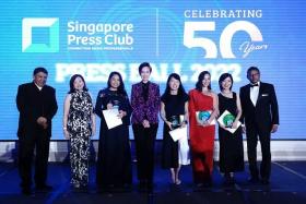 Communications and Information Minister Josephine Teo (fourth from left) and Singapore Press Club president Patrick Daniel (left) with "Rising Stars" award recipients and sponsors at the Press Ball dinner.