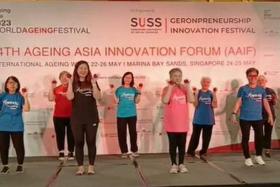 Actress Jin Yinji (foreground, in pink) does the viral Flower dance at the 14th Ageing Asia Innovation Forum on May 24.
