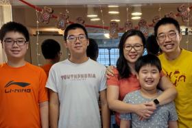 Mr Joseph Gan (right), his wife Tay Li Ping and their sons (from left) Daniel, Joshua and Gabriel.
