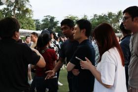 Attendees speaking with event staff at the Sky Lantern Festival at Sentosa on Feb 21.