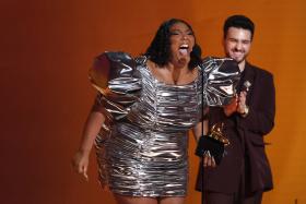 Lizzo (left) accepts the Record Of The Year award for About Damn Time.