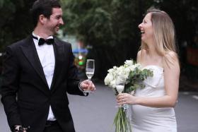 Mr Matthew Mitchener (left) and Ms Janelle Nuyts celebrating their wedding in the car park of their housing compound in Shanghai on April 30, 2022.