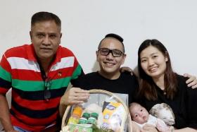 Ms Jasmine Teo (right) with her husband, Mr Nelson Ho (centre), their newborn daughter, Jayann, and taxi driver Victor Albert (left).