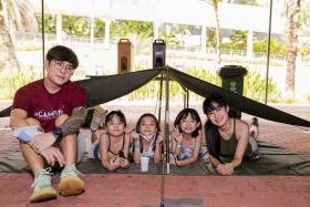 Learn how to pitch a basha tent during the one-night camp for families at Singapore Discovery Centre.
