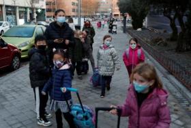 Children heading back to school after the Christmas break in Madrid, Spain, on Jan 10, 2022.