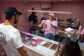 A customer being served at La Putaria waffle store in Ipanema, Rio de Janeiro, Brazil, on June 2, 2022.