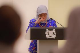 President Halimah Yacob tears up as she speaks during an appreciation event for Covid-19 service staff, at the Istana on Jan 27, 2022.