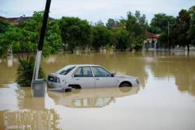 A car partially submerged in flood waters in Melaka on Jan 3, 2022.