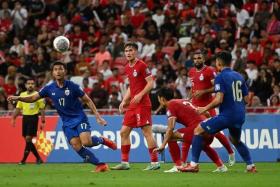 Singapore and Thai players in action in the World Cup qualifier on Nov 21.