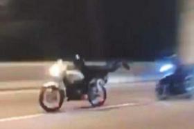Footage show two bikers going at high speed along the Tun Dr Lim Chong Eu Expressway while the one in front performs a stunt.