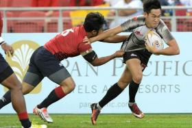 Singapore&#039;s Mattias Chia brushing aside his Malaysian opponent to score a try in a 19-7 win to clinch the host nation’s first SEA Sevens trophy in 2017. 