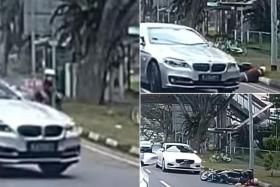 Dashboard camera footage shows a silver BMW changing lanes into the path of an oncoming motorcycle in the leftmost lane.