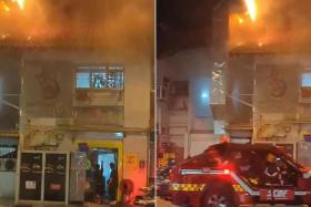 A video showing bright orange flames on top of a two-storey building, before firefighters arrived to put out the fire.