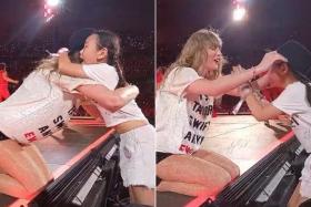 Giselle Heng gets a hug and hat from pop star Taylor Swift during her performance of 22 at the Eras Tour opening night at the National Stadium on March 2.