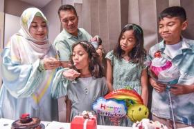 Mr Salihin Ahmad Perbah and his wife Khairunnisa Abdul Karim celebrating the birthdays of all four children at the same time. 