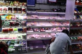 Stocks of chicken is seen becoming lesser at Fairprice Chinatown Point on May 25, 2022.