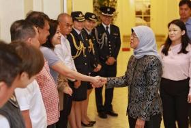 President Halimah Yacob thanking staff and butlers during the last day of her tenure at the Istana on Sept 13.